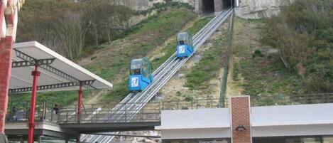 A cable car system with a bar and seating area below.