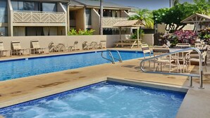 A swimming pool with lounge chairs and a covered seating area. - Stunning Ocean Views Steps from Sugar Beach (Kihei)