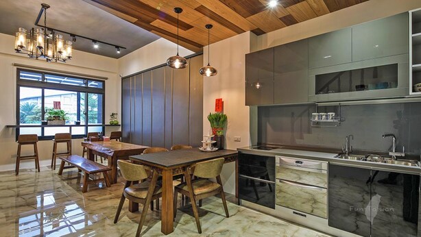 A modern kitchen with a marble countertop, stainless steel appliances, and wooden ceiling beams. - Wujie Childlike B&B (Wujie)