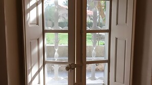 A room with a corner door leading to an outdoor area.