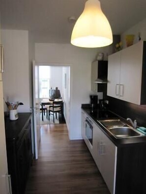 Enjoy cooking in this well-equipped kitchen with a central island, sink, and stove, and dine in the adjacent dining area.