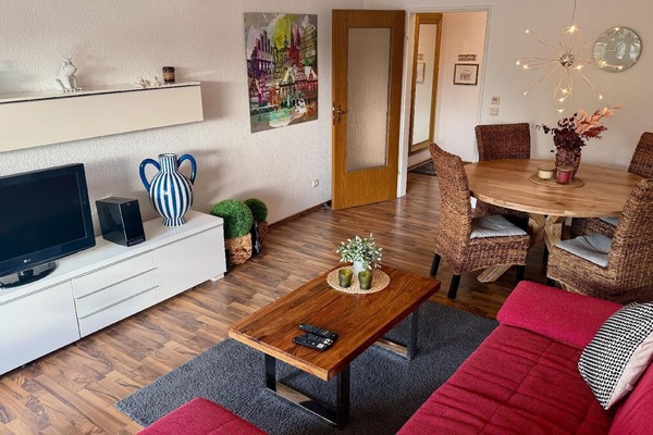 Living room with dining area and balcony.