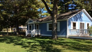 A two-story blue house with a white porch and a small deck. - ☀️Summer dates available!  (Mears)