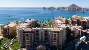 A coastal hotel with multiple buildings, a swimming pool, and a view of the sea and mountains. - Luxury Oceanfront Villa - Endless Panoramic Ocean and Pool Views! (Cabo San Lucas)