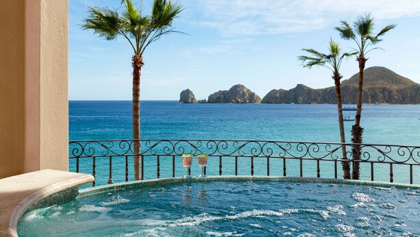 A pool with a view of the sea and palm trees. - Luxury Oceanfront Villa - Endless Panoramic Ocean and Pool Views! (Cabo San Lucas)