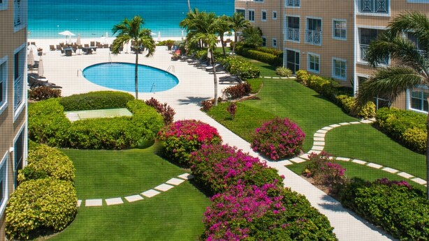A resort with a pool, beach, and ocean view. - Regal Beach Club #231 (Seven Mile Beach)