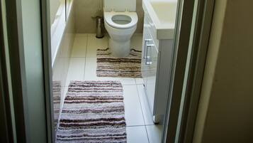 A bathroom with a toilet, sink, and bathtub.