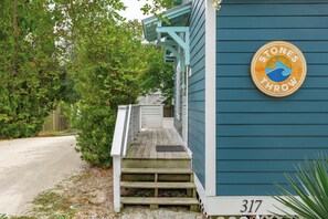 A wooden staircase leading to a house with a sign reading "Stones Throw" and the number 317.