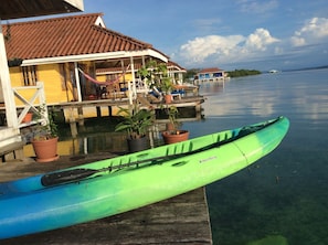 Relax by the serene waterfront, where a kayak awaits and a tranquil atmosphere invites you to unwind.