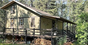 Cozy cabin with a single-story design, featuring a front entrance and a small porch area.
