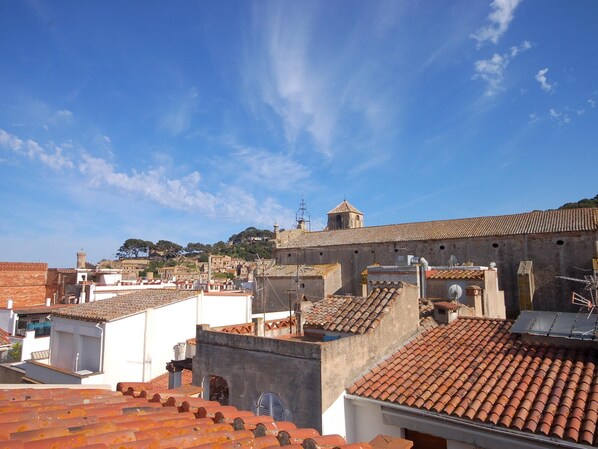 A historical town with terracotta-roofed buildings and a prominent church with a bell tower. - CENTRIC APARTMENT with POOL in TOSSA (Tossa de Mar)