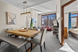 Enjoy a cozy dining area with a wooden table and bench, offering a view of the surrounding landscape.