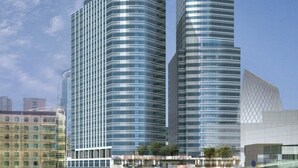 Two modern high-rise buildings with reflective glass facades, surrounded by other buildings and greenery. - Seda Residences Makati (Makati)