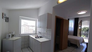 A compact kitchen with a window, a sink, a stove, and a small refrigerator. - Studio apartment in Rovinj with Seaview, Terrace, Air condition, WIFI (4686-6) (Rovinj)