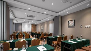 A conference room with multiple tables and chairs, equipped with water bottles and nameplates. - MPALACE HOTEL KUALA LUMPUR (Kuala Lumpur)