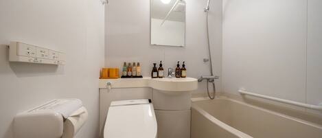 A modern bathroom with a toilet, sink, and bathtub.