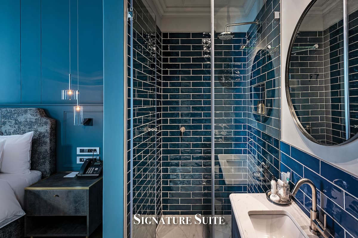 signature suite | bathroom | designer toiletries, hair dryer, bathrobes, slippers