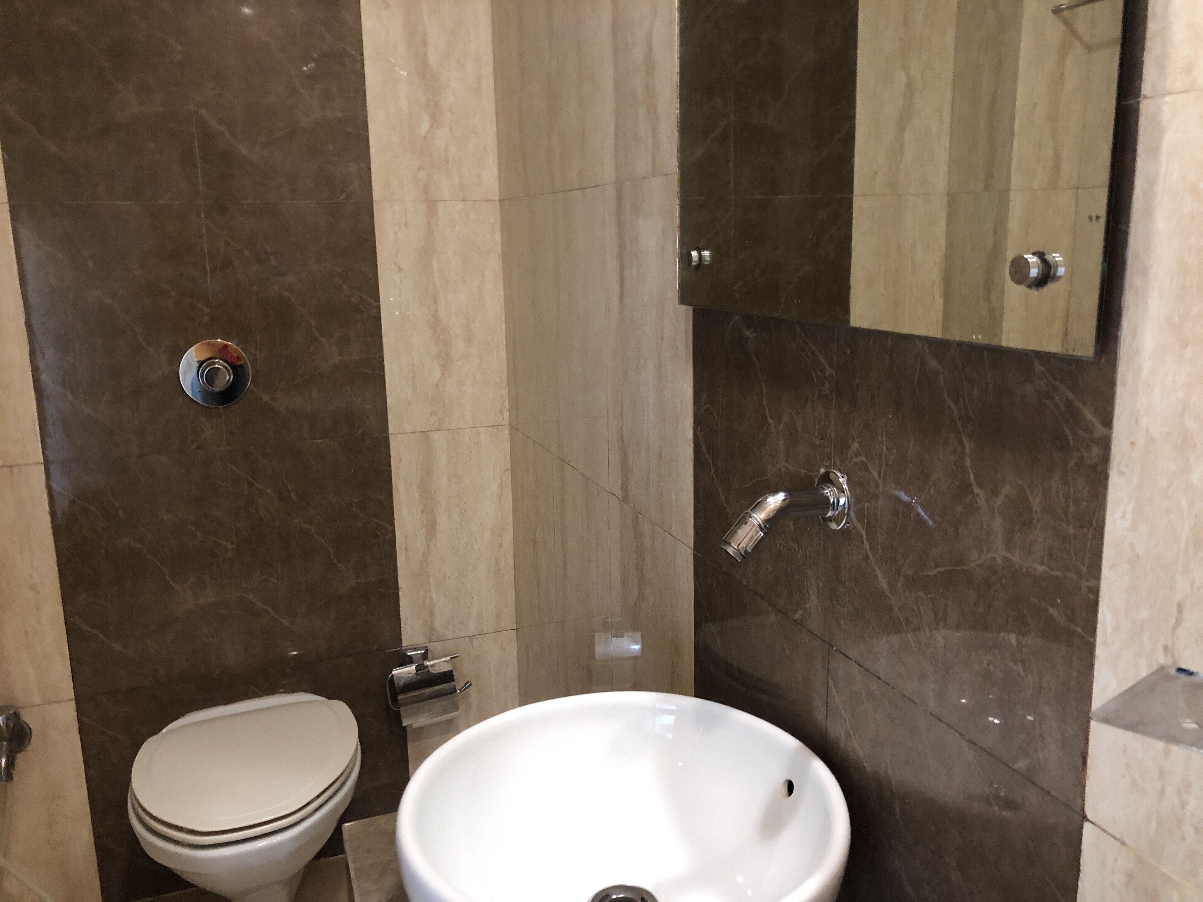 A bathroom with a toilet, sink, and shower.