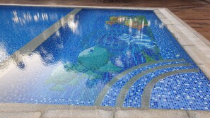 A mosaic pool with a clear water surface reflecting the sky. - Resort Silver Hills Lonavala (Mawal)