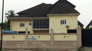 A two-story building with a tiled roof, a gated entrance, and a sign for "Eliata Suites." - Eliata Hotel & Suites (Lagos)