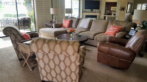 A living room with a sofa, two armchairs, a coffee table, and a TV. - Palm Valley with Beautiful View and Platinum Membership (Palm Desert)