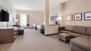 A hotel room with a desk, two beds, a sofa, a TV, and framed pictures on the wall. - Comfort Inn & Suites Rock Hill Northeast (Rock Hill)