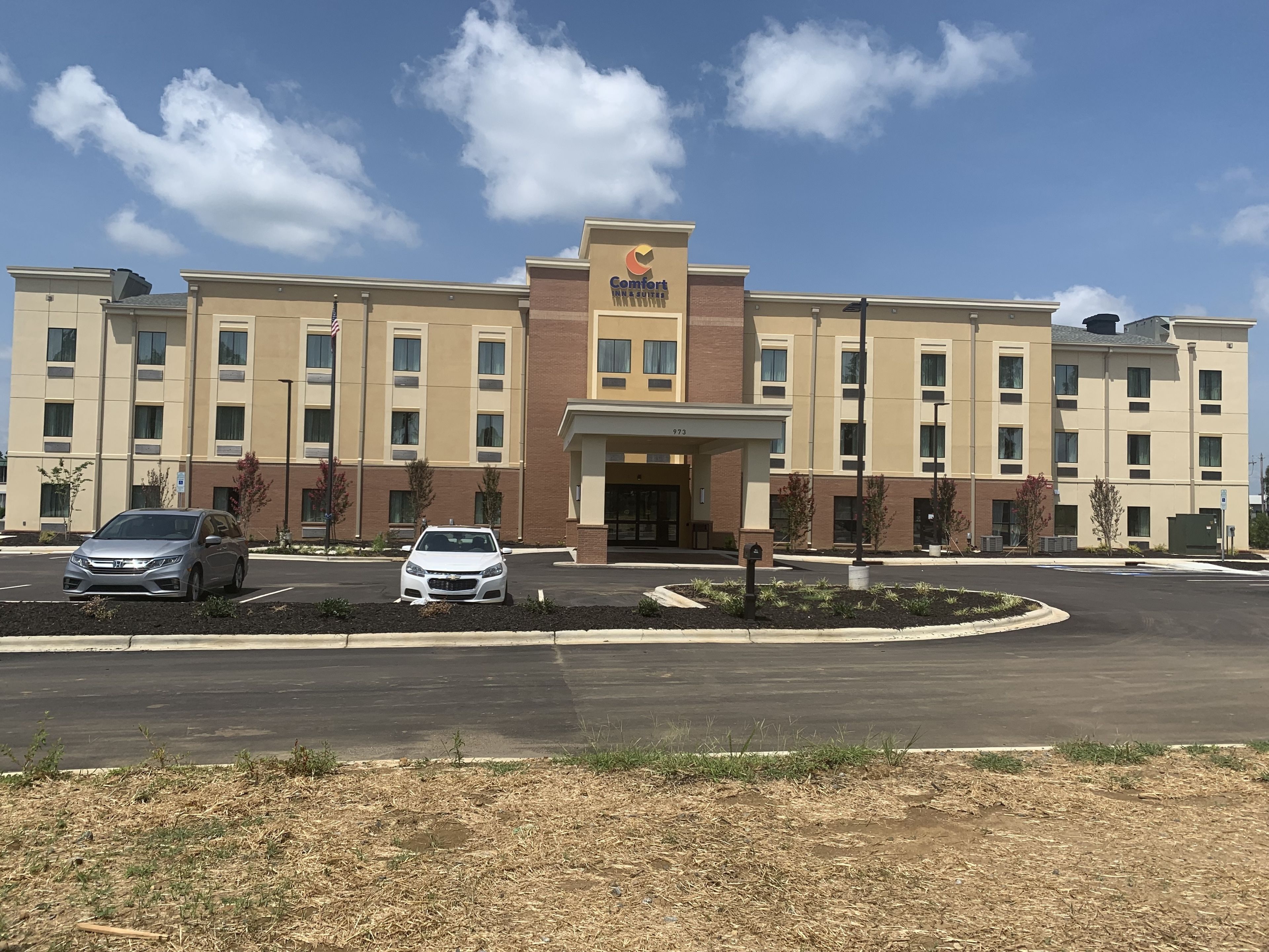 A Comfort Inn hotel with a parking lot and a building facade.