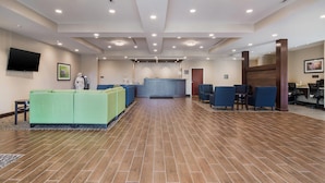A spacious lobby with a reception desk, seating area, and a television mounted on the wall. - Comfort Inn & Suites Rock Hill Northeast (Rock Hill)