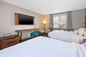 A hotel room with two beds, a desk, a chair, a TV, and a window with curtains. - Fairfield Inn & Suites by Marriott Kalamazoo (Kalamazoo)