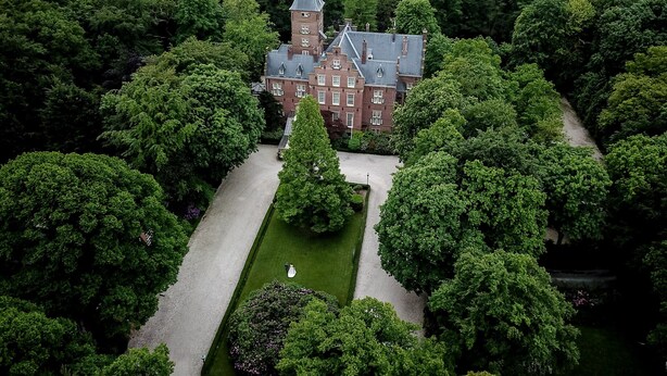 An aerial view of a large, historic building surrounded by dense greenery. - Kasteel de Wittenburg (Wassenaar)