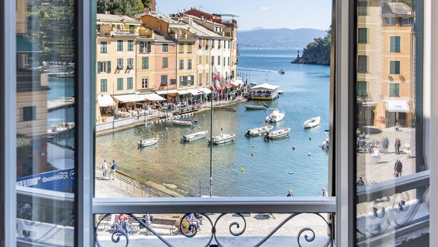 A view from a window overlooking a coastal town with buildings, boats, and a clear sky. - JOIVY La Finestra Sulla Piazzetta a Portofino (Portofino)