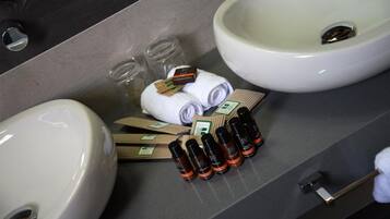 Bany amb dues rentapesos, un mirall i productes de tocador, incloent ampolles i tovalloles.