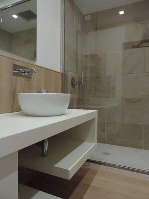 Deluxe vierpersoonskamer | Badkamer | Een douche, gratis toiletartikelen, een haardroger, een bidet