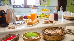 A breakfast buffet with various food items, beverages, and condiments. - Sicily's View (Mascalucia)