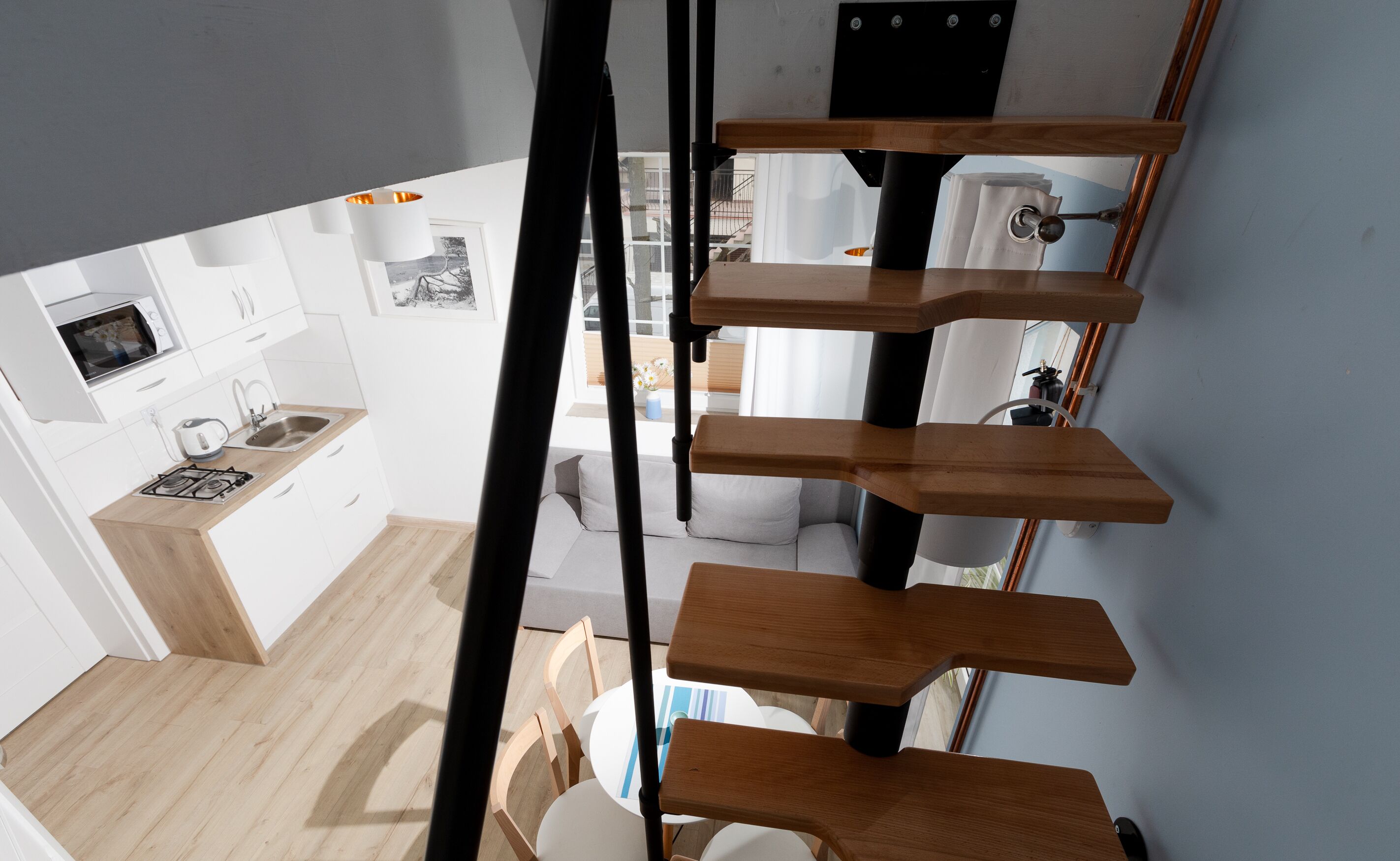 A modern kitchen with white cabinets, a built-in microwave, and a gas stove.