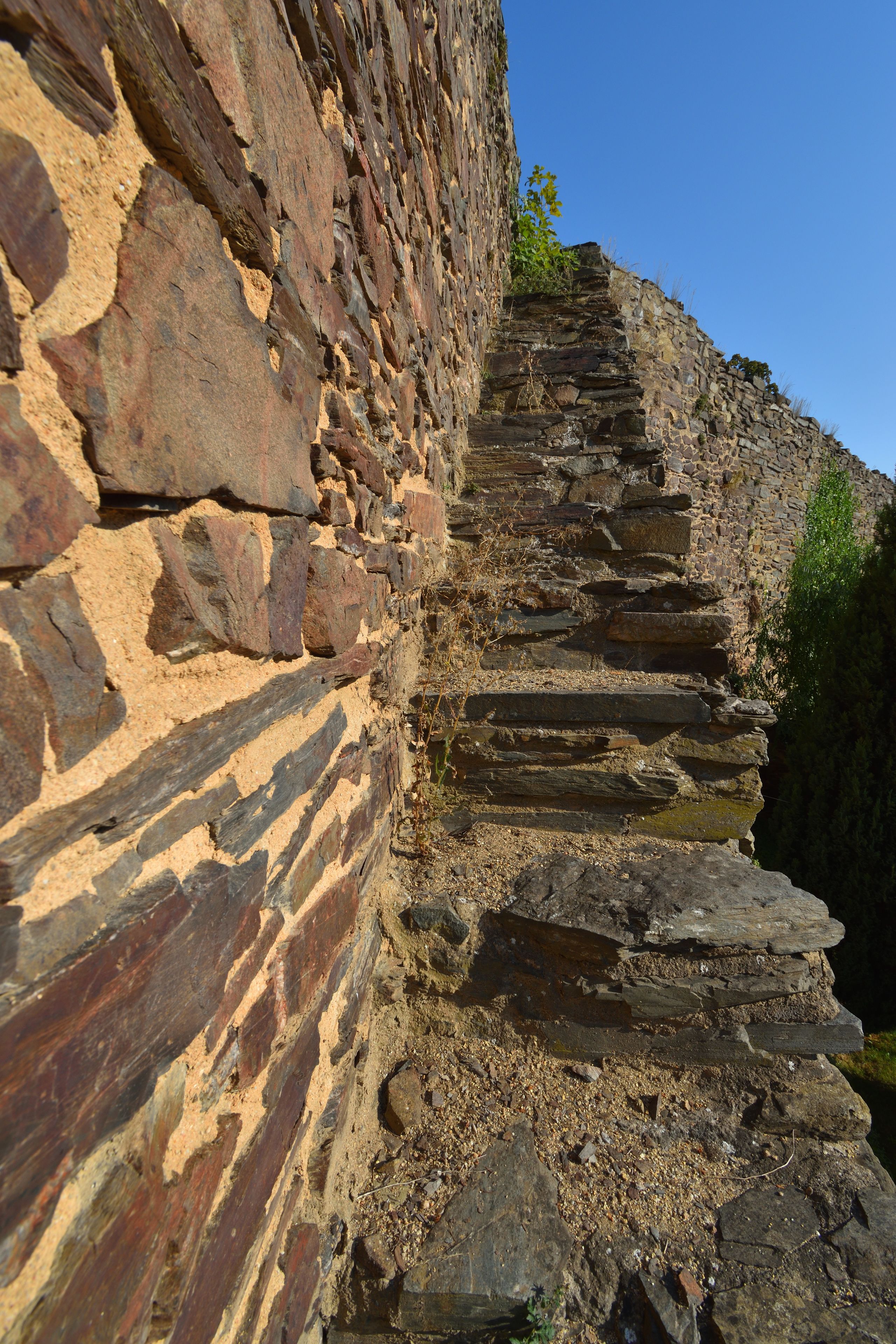 A stone staircase leading up a rocky cliff.