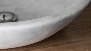 A close-up of a curved, light-colored surface, possibly a part of a table or countertop. - Hotel Restaurante Lorca (Weinsberg)
