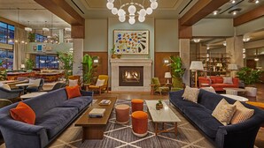 A spacious lobby with a fireplace, comfortable seating, and a modern chandelier. - The Hoxton, Chicago (Chicago)