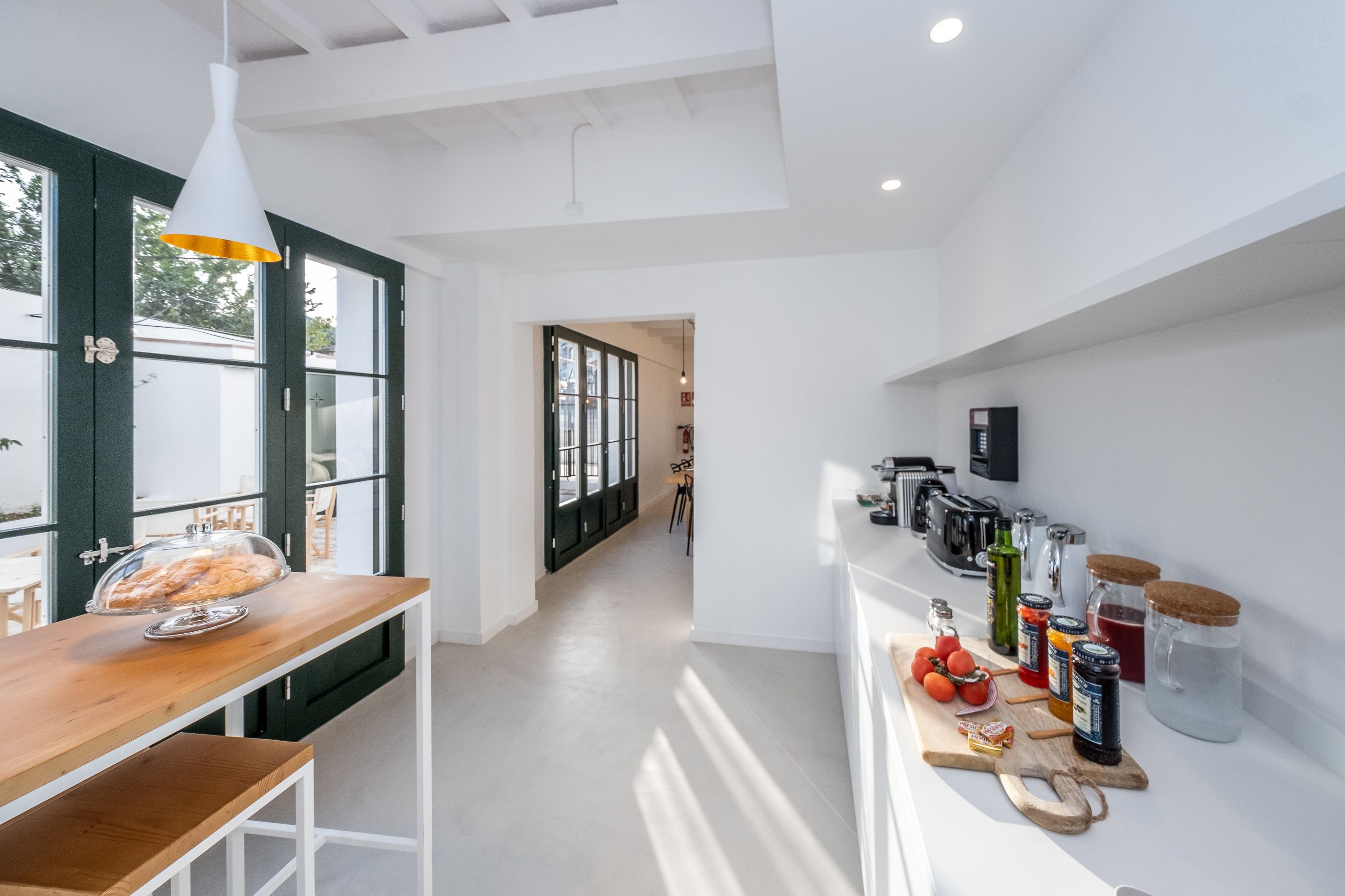 Una cocina moderna con encimera de madera, una exhibición de pan y diversos electrodomésticos.