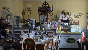 A cozy cafe with a wooden counter, various kitchen utensils, and a vintage decor. - Kulturhof (Lenzen)