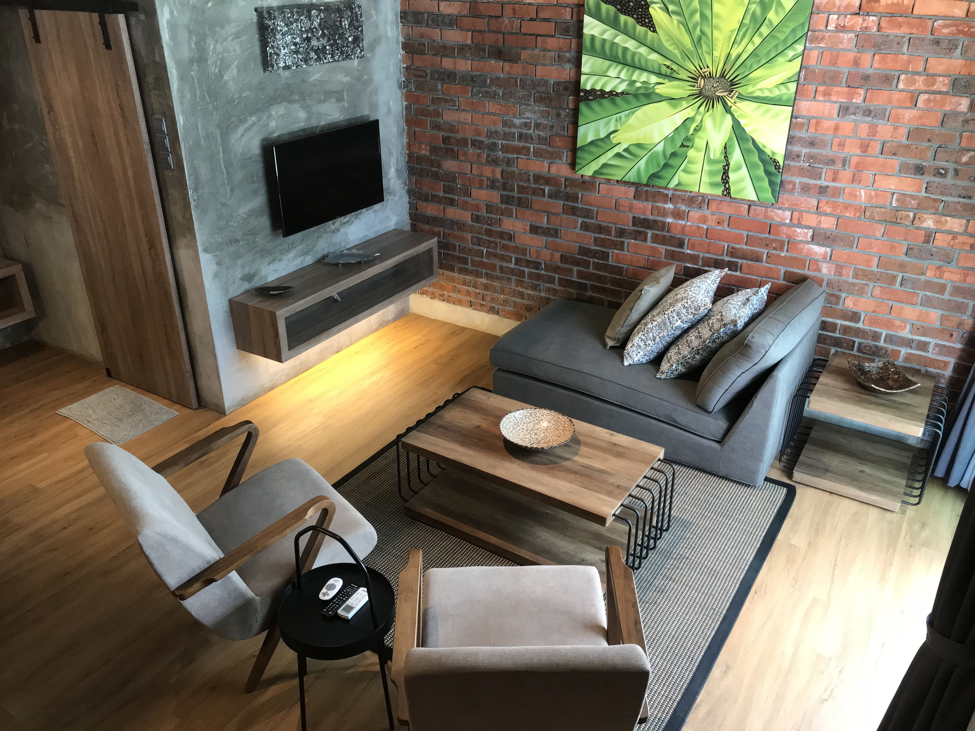 A modern living room with a fireplace, a sofa, and a coffee table.