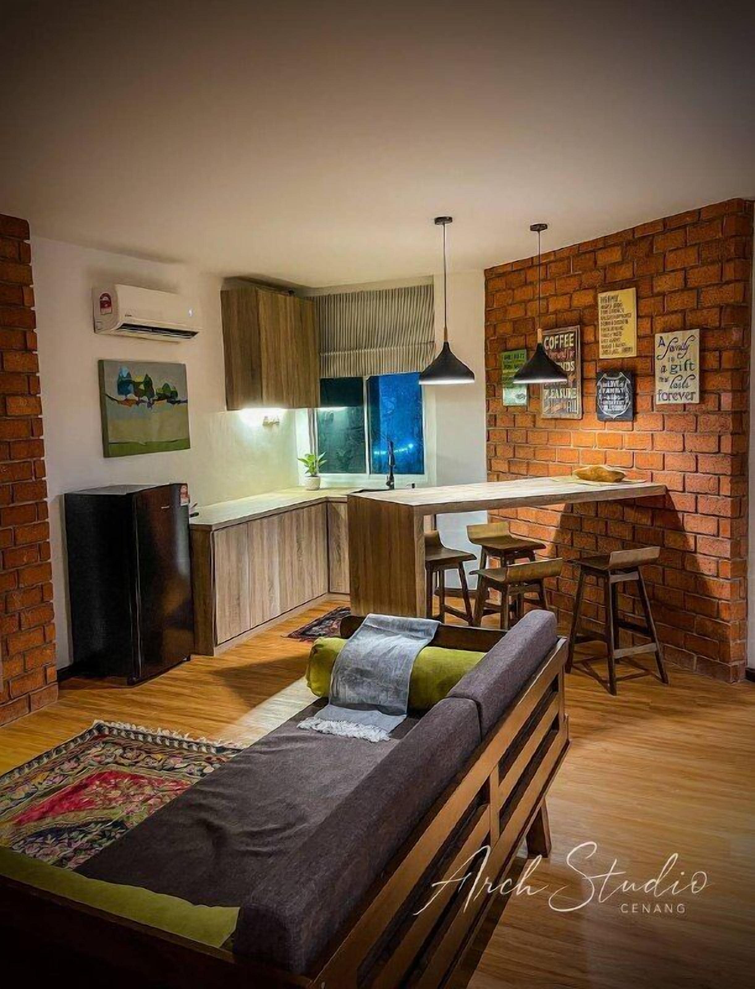 A compact living space with a kitchenette, a dining area, and a seating area with a sofa and a small table.