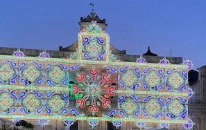 A building facade with intricate geometric patterns and a central decorative element.