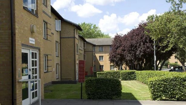 A building with a brick facade, a door, and a window. - Platt Hall - Campus Accommodation (London)