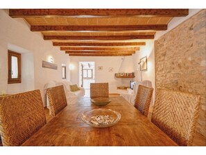 Enjoy meals in this cozy dining area with a rustic table and comfortable chairs.