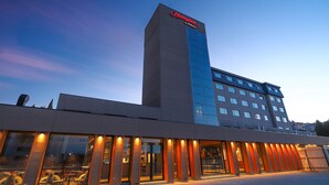 A modern hotel with a prominent Hampton by Hilton sign, large windows, and a flat roof. - Hampton by Hilton Bariloche (San Carlos de Bariloche)