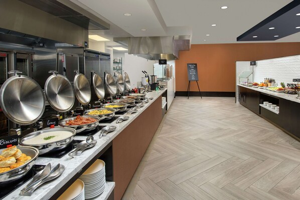 A buffet area with various food stations, including options like biscuits, gravy, and bacon. - Embassy Suites by Hilton Knoxville Downtown (Knoxville)