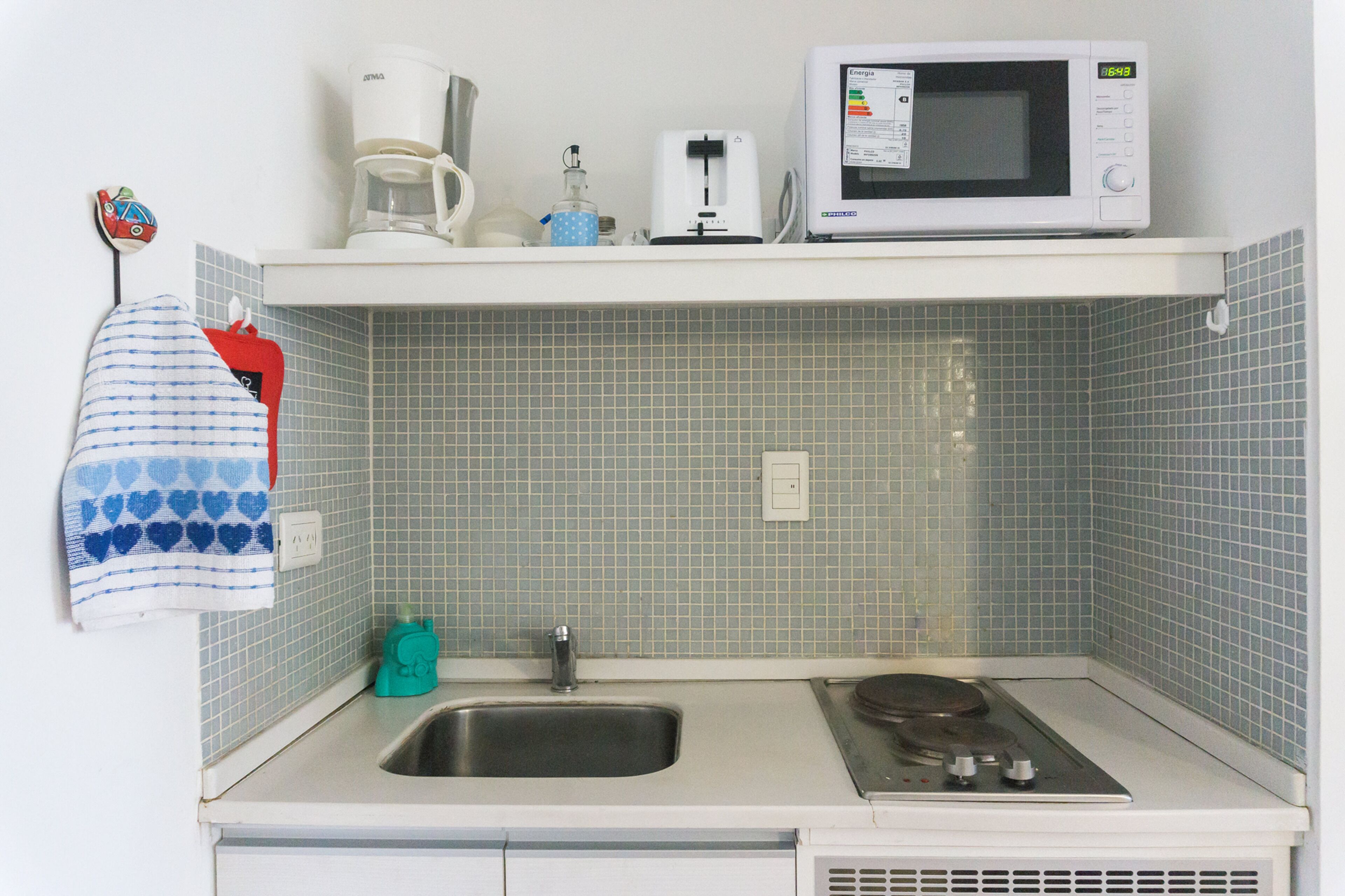 A kitchen with a microwave, toaster, and coffee maker on the countertop.