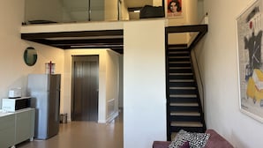 A modern apartment with a kitchen, a dining area, a staircase, and a living room. - Rivadige Suite 4 with beautiful view on the river (Verona)