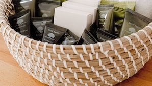 A wicker basket containing toiletries and a white towel. - The Caledonian Inn (Port Fairy)